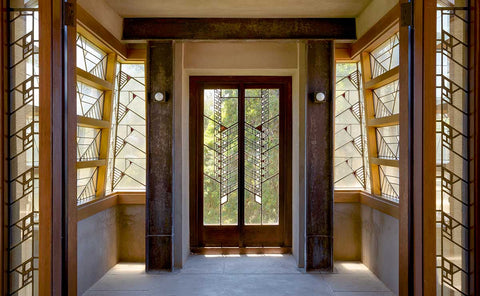 In the glass enclosed entry hall of Hollyhock House.  The window panes have a stylized hollyhock pattern.