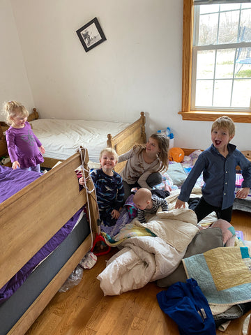 Messy bedroom full of quilts