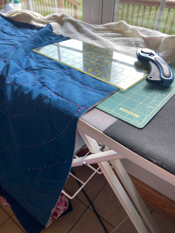 Maria Fisher from Delightfully Quilted hand quilting set-up on a ironing board