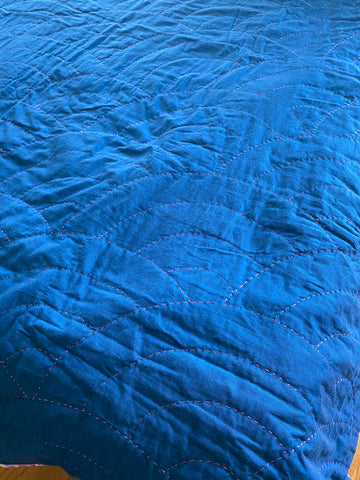Maria Fisher/Delightfully Quilted's up close look at the pink thread top quilting on the blue indigo quilt