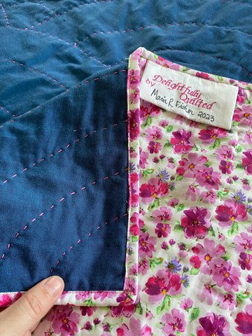 Maria Fisher/Delightfully Quilted's details of the pink and white floral binding and batting of the Hope bed quilt