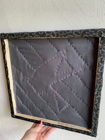 The wooden framed quilted block