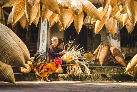 artisan lady from vietnam weaving wall basket