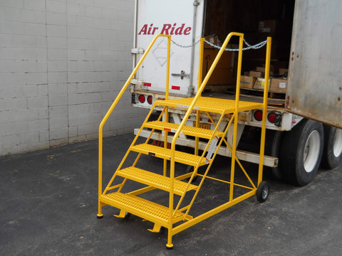 Yellow Semi-Truck Trailer Access Rolling Ladder up against a semi trailer