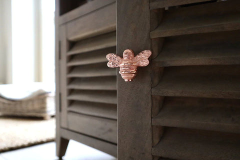 A picture of a brass bee cabinet knob in rose gold finish.