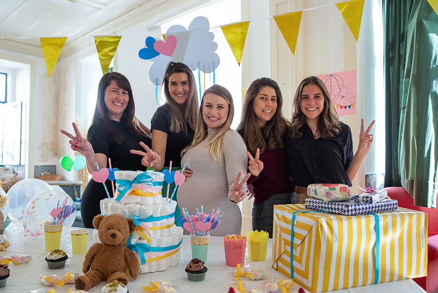 A group of women posing for a photo at a baby shower.