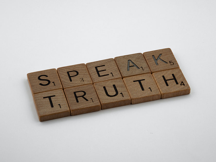 Scrabble tiles that spell "Speak truth"