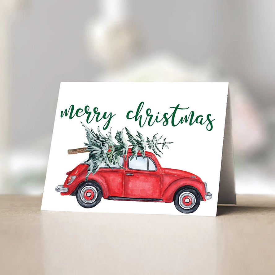 The classic red truck Christmas tree design gets an update with this playful card. A red VW Beetle replaces the truck for a fun twist on a classic.