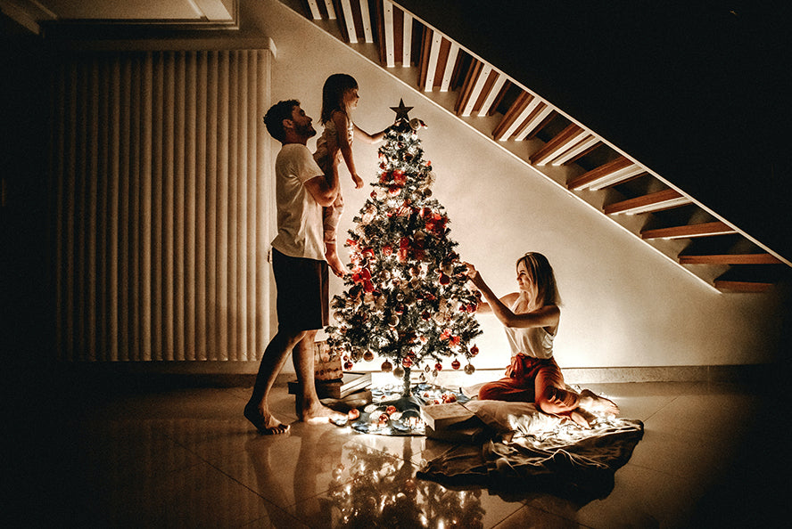 A family around their Christmas tree.