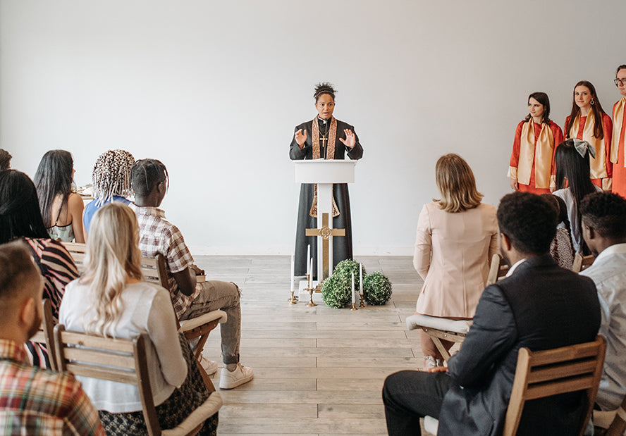 A female pastor leads her congregation.