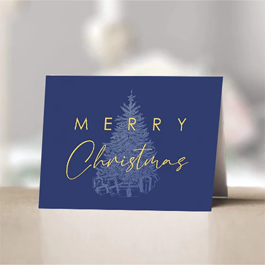 A gold Christmas tree over blue on a holiday card.