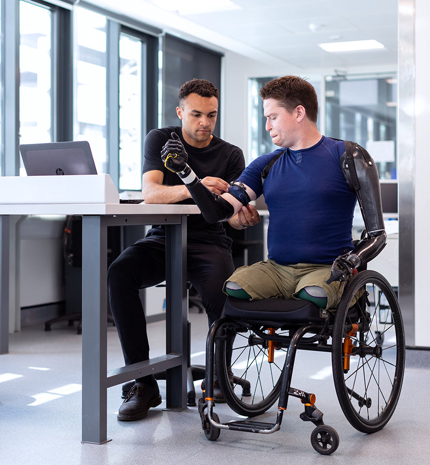 A paraplegic in a wheelchair getting bionic limbs installed.