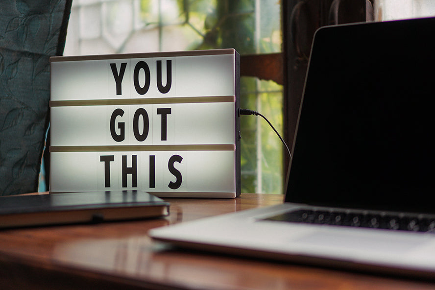 A card next to someone workstation that reads "You got this!"