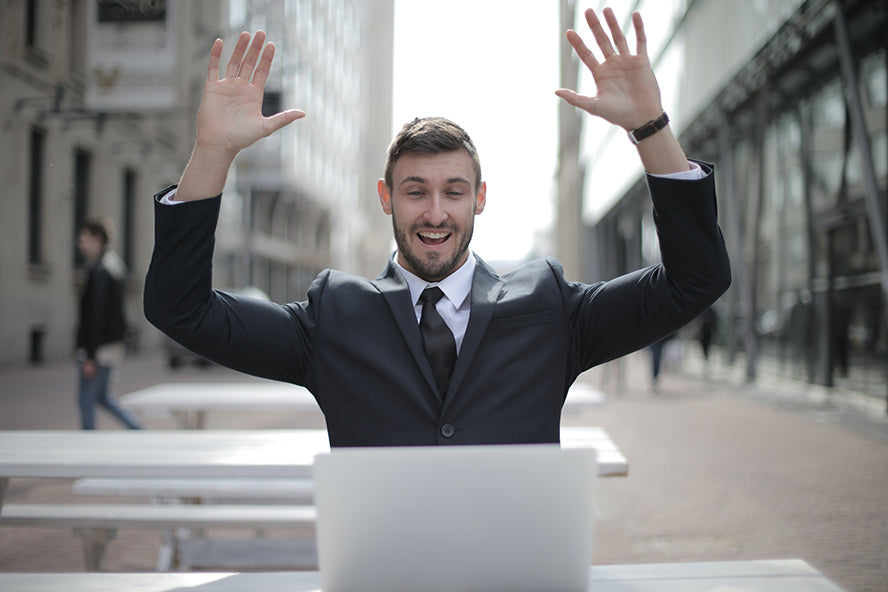 A professional throwing up their hands and cheering.