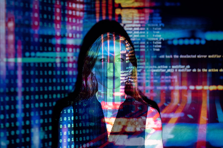 A woman with intricate data projected on her face and surrounding walls.