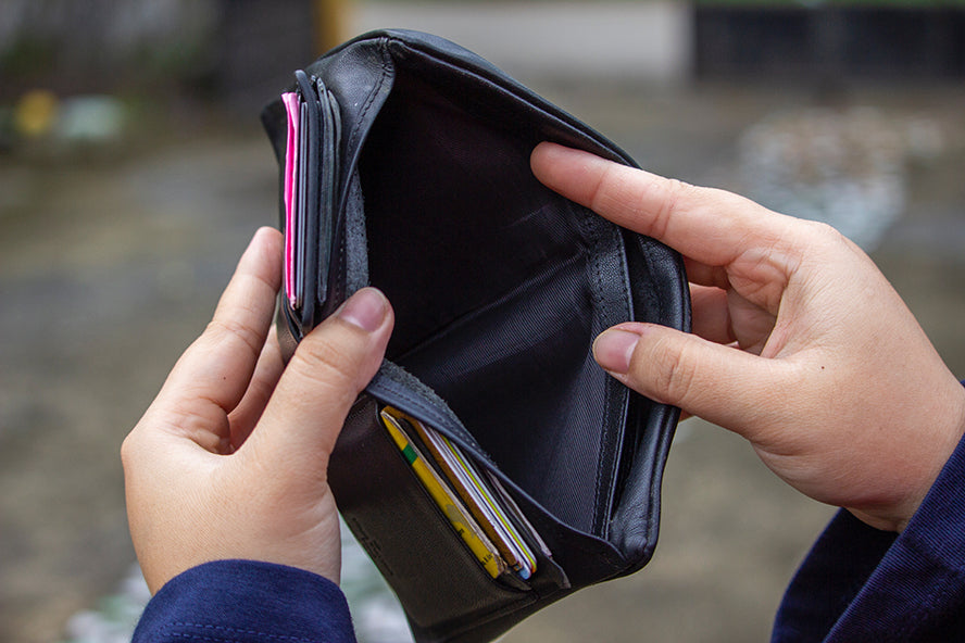 Overhead shot of a person holding open an empty wallet.