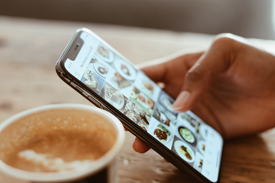 Close up of someone's phone. The person is using Instagram.