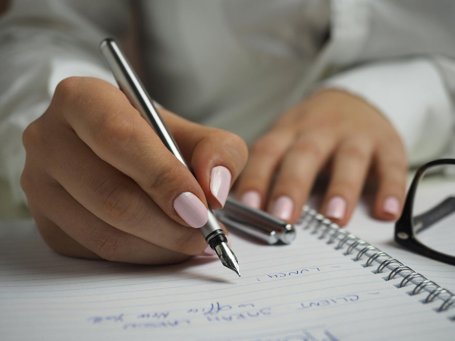 A person handwriting a card.