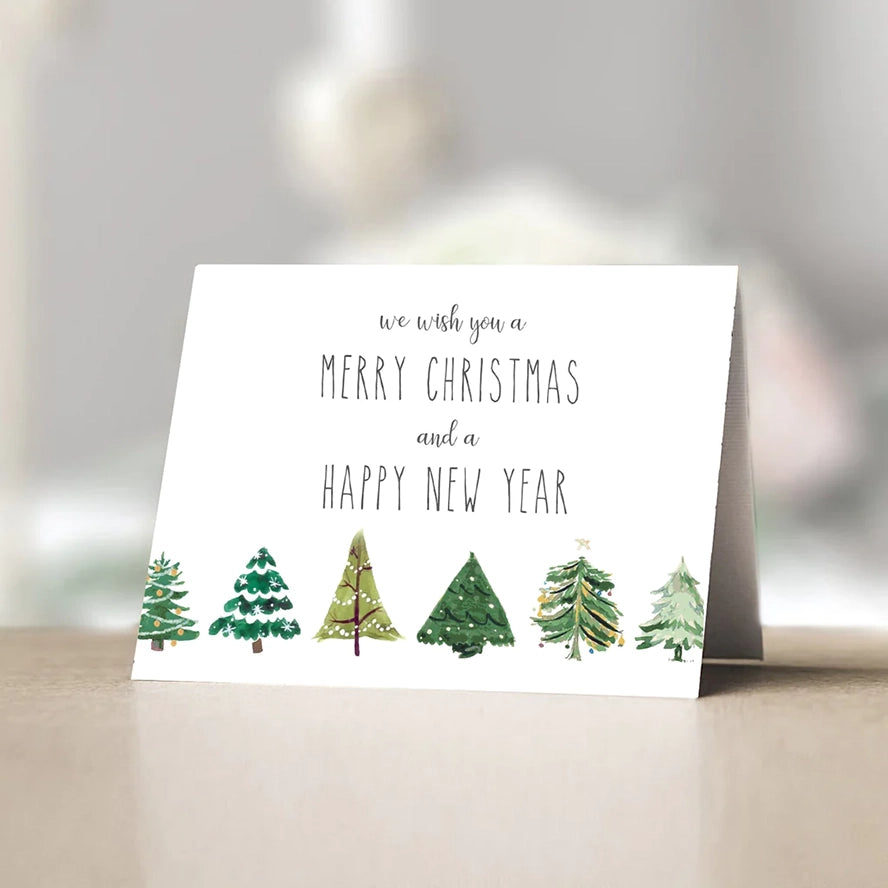 This card features cheerful little illustrated Christmas trees across the bottom and the words, "We wish you a merry Christmas and a happy New Year." 