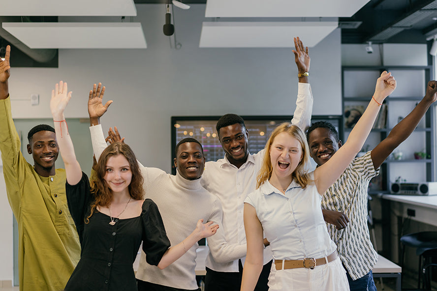 Office workers cheering for a coworker.