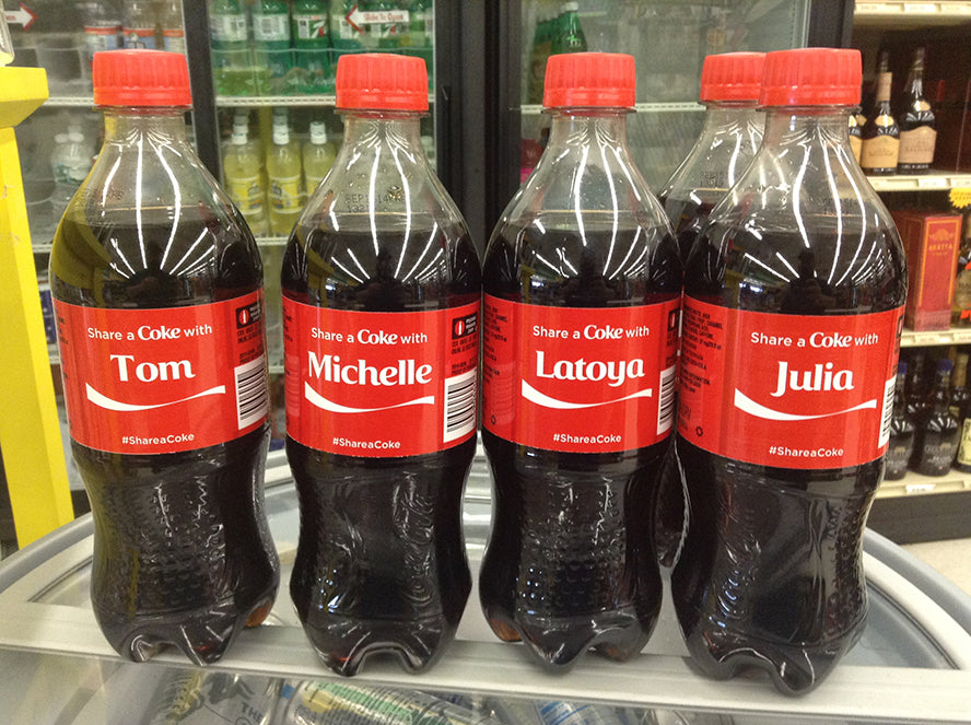 A row of personalized coke bottles featuring different names.