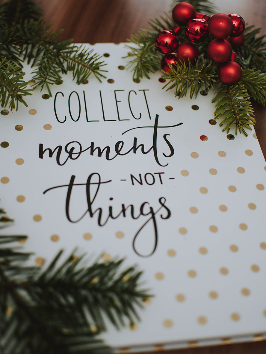 A holiday card that reads "Collect moments, not things."