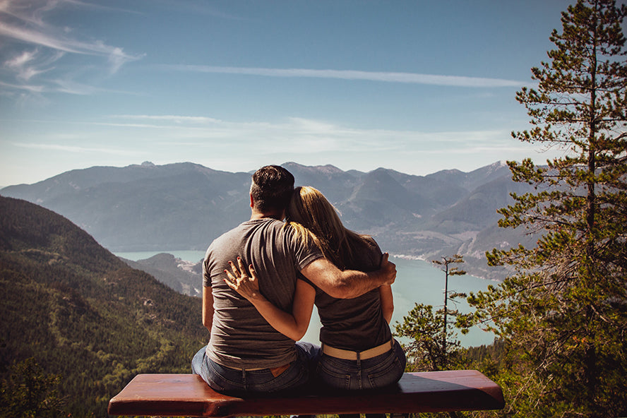 A couple with their arms around each other.