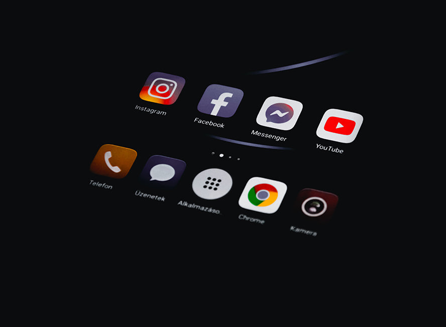Social media icons on a phone screen.
