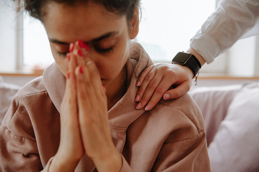 A woman being comforted.