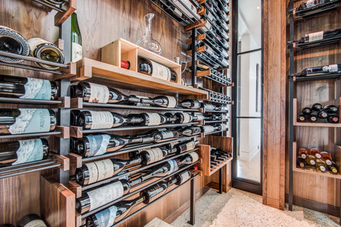 Wine cellar with rich wood accents and black finishes.