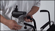Using Accessories - Caregiver Joystick Mount on Push Handles on Deluxe Model