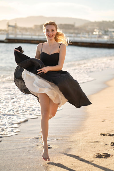 replica of Marlin Monroe running photo in black linen Bardot dress with petticoat