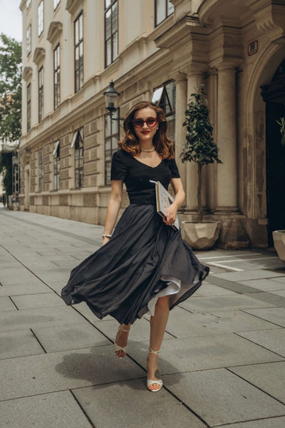 Anastasiia Nova in Vienna walking down the street with a Gaâla vintage-inspired dress with petticoat