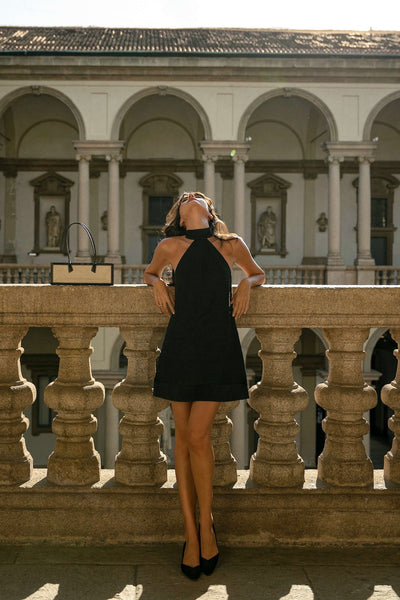 Paola Cossentino modelling in Paris wearing short linen backless cocktail dress