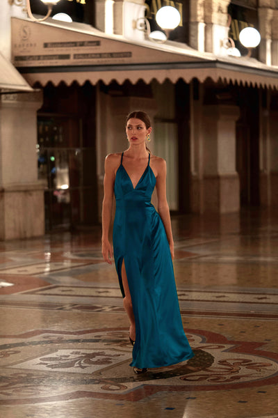 model on a cat walk in Milan center wearing royal blue maxi silk dress with v neck
