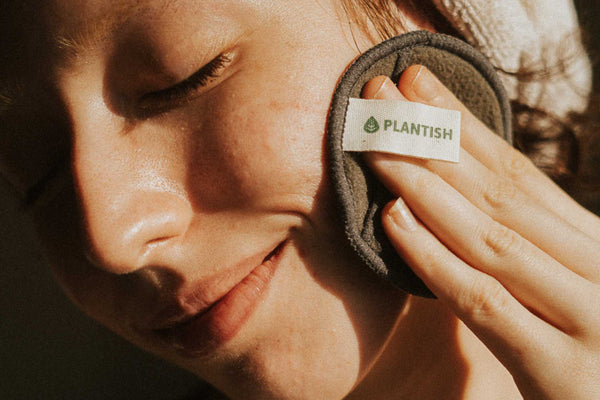 Close up of woman using Plantish Future reusable cotton round