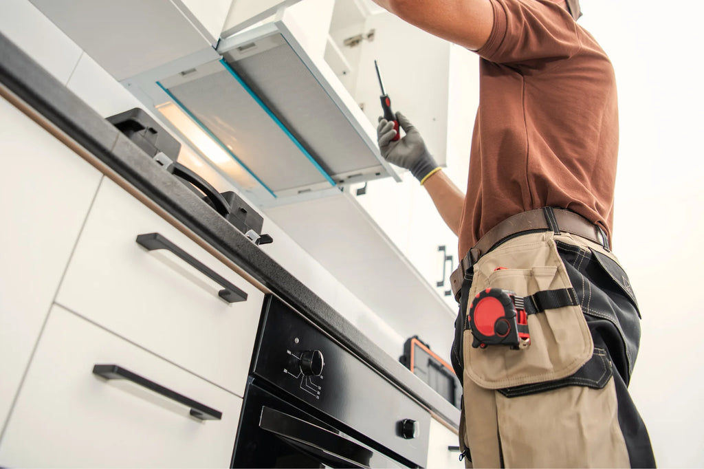 Man adjusting cabinets in kitchen