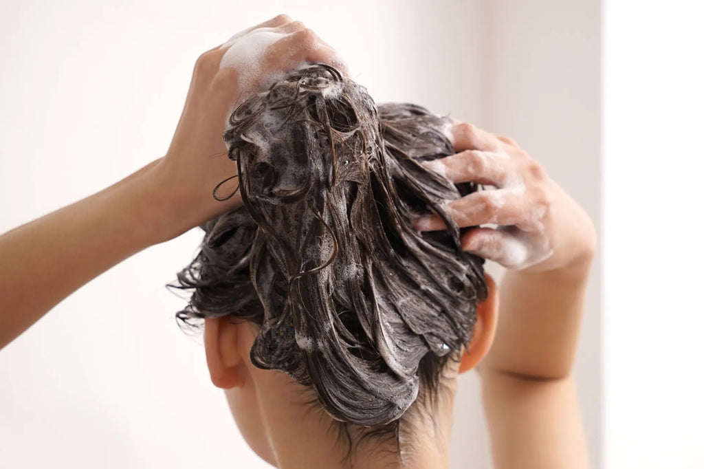 Close up of woman washing hair in bathroom