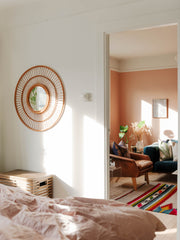 View of mirror and living space from master bedroom