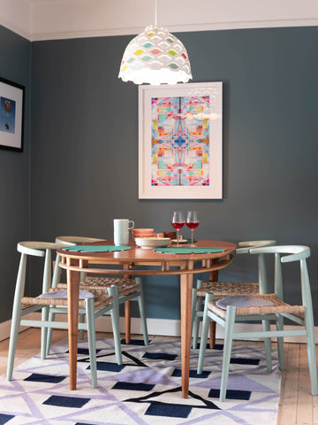 View of colorful dining room with dark grey blue interior paint