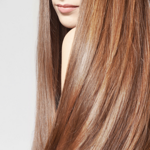 Woman with long straight light brown caramel hair color