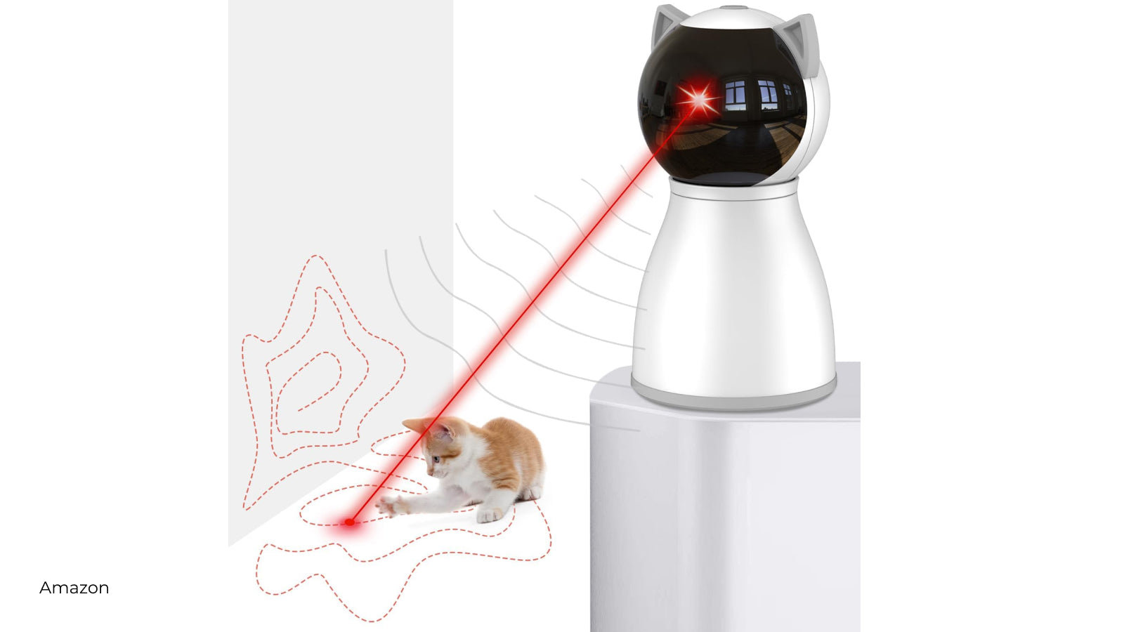 A beige and white cat plays with a laser projected from a cat shape device