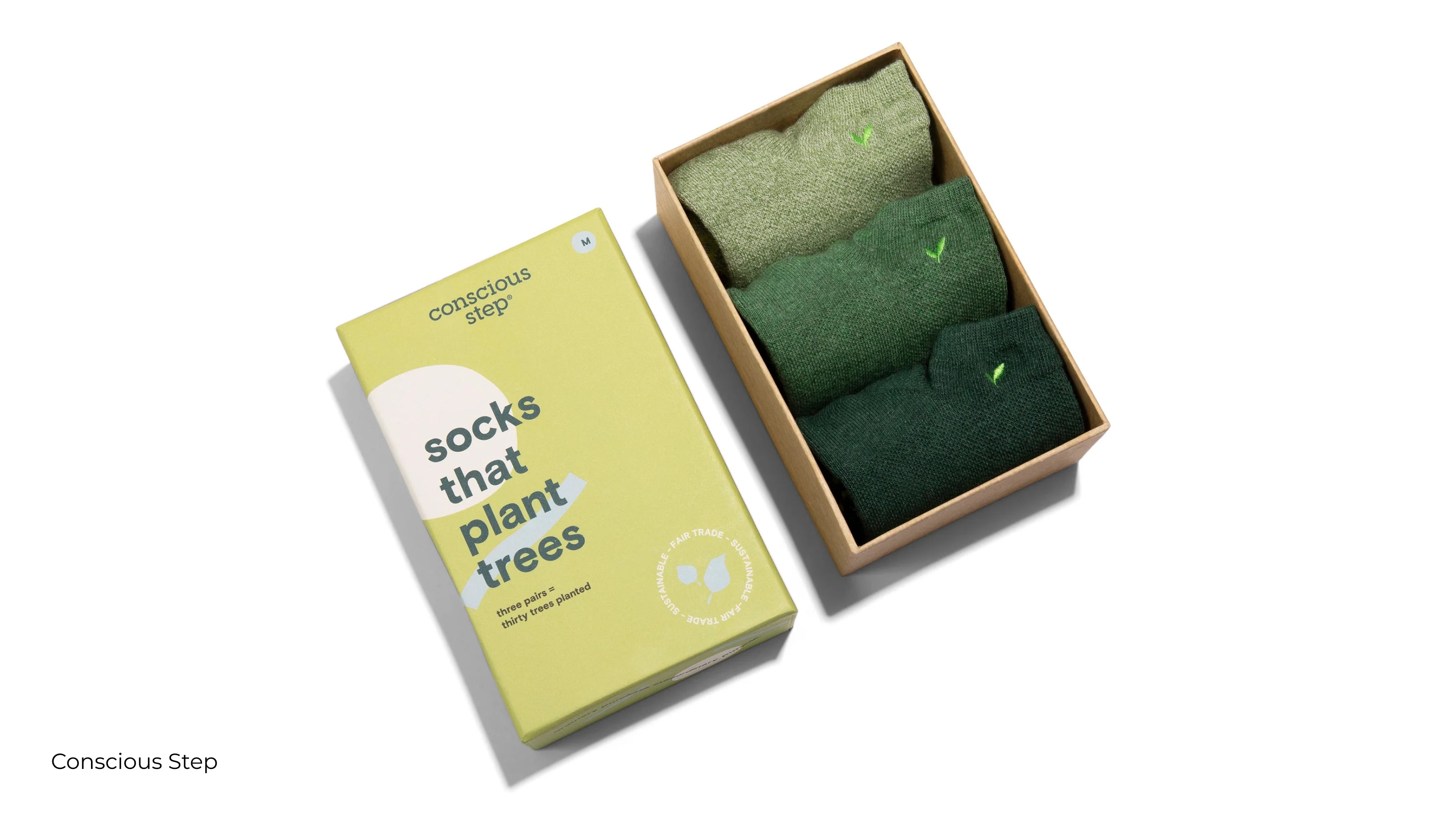 A boxed set of green socks with plant logo on them from Conscious Step