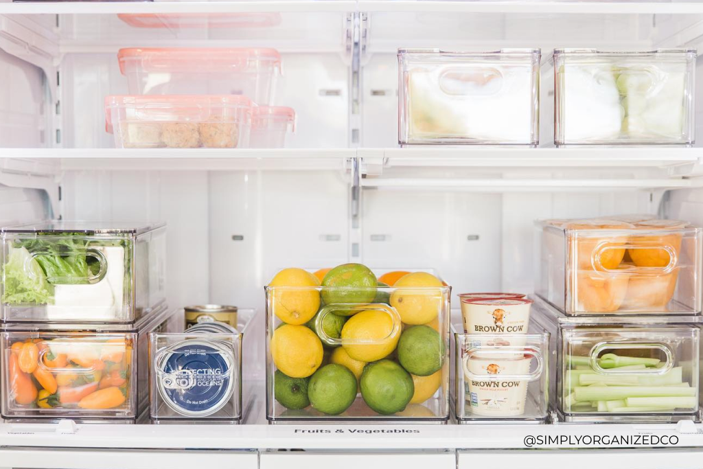 A clean and organized refrigerator filled with fruits and vegetables