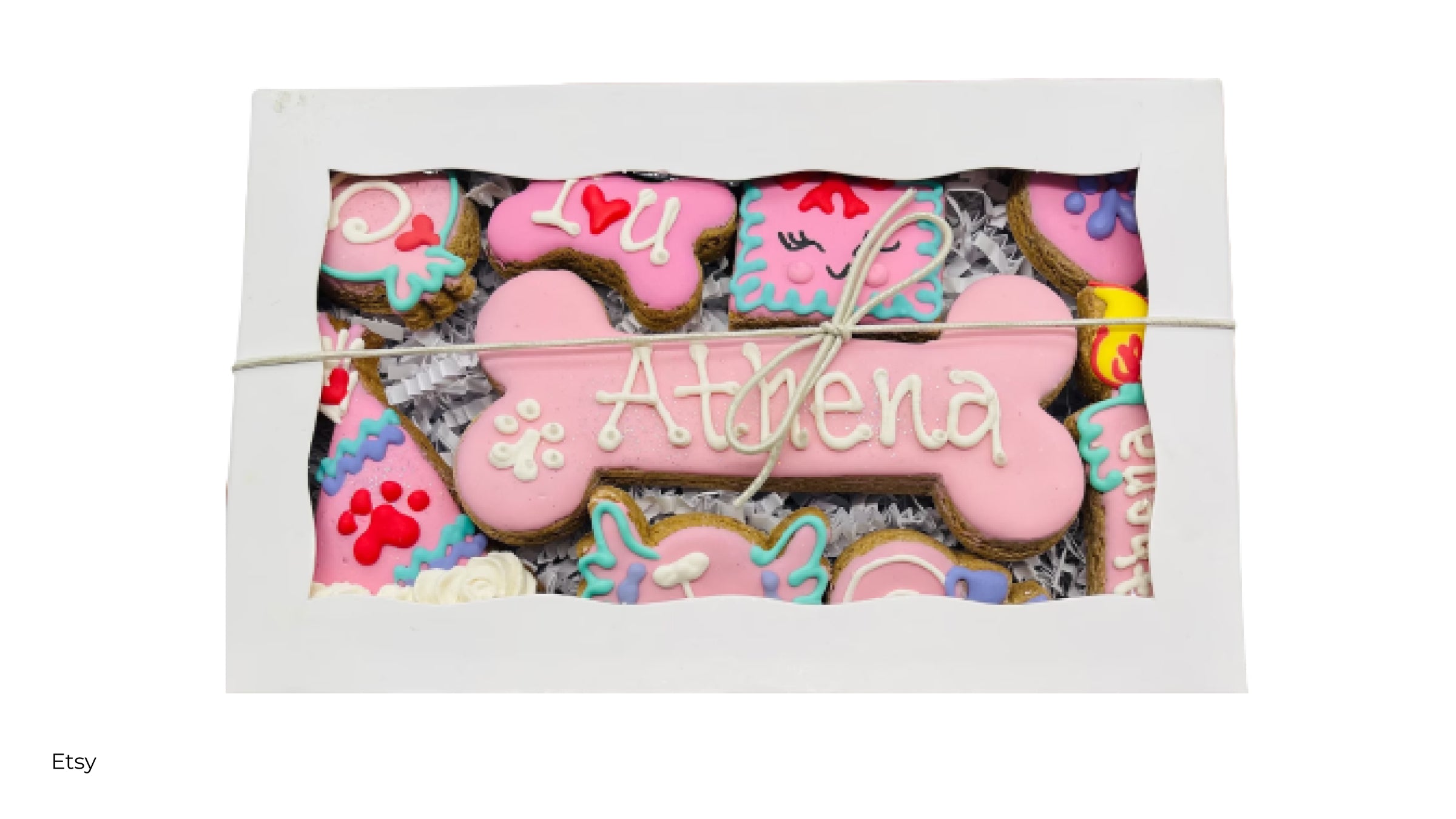 A custom box of dog treats personalized with the name Athena and other sayings