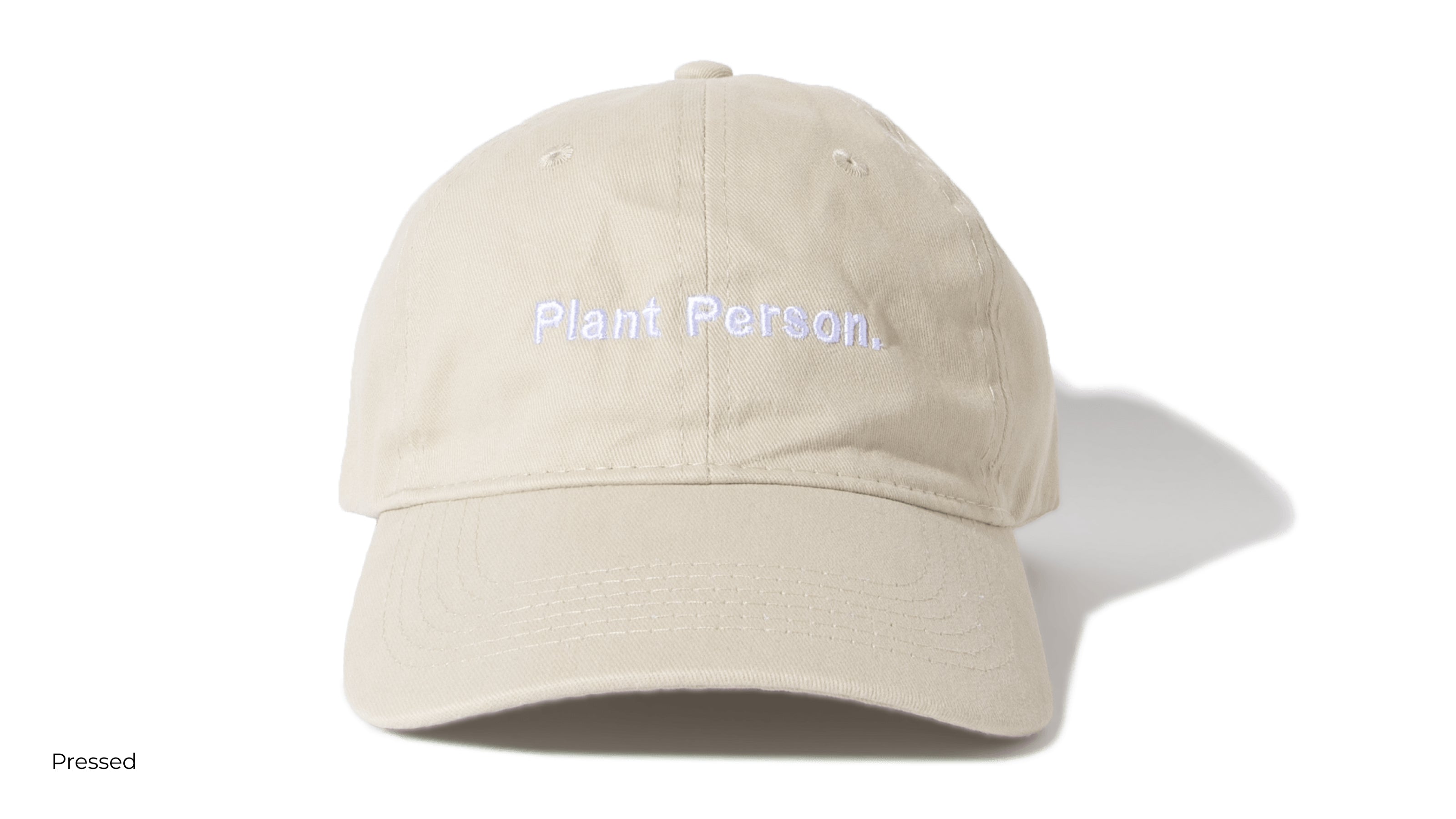 A light tan hat with the saying plant person written across the front