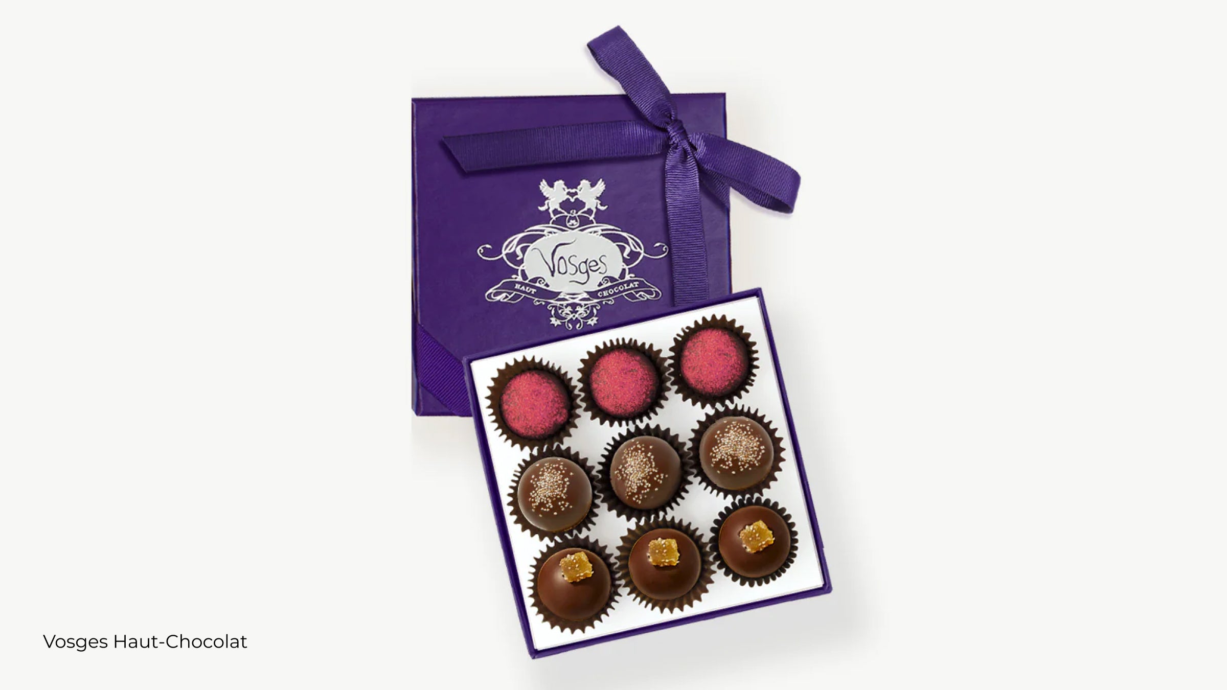 A purple box filled with nine vegan chocolate truffles from Vosges Haut-Chocolat