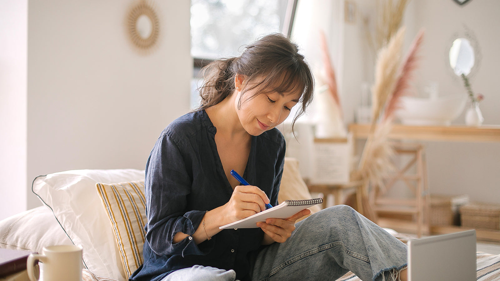 A woman writing on a notepad