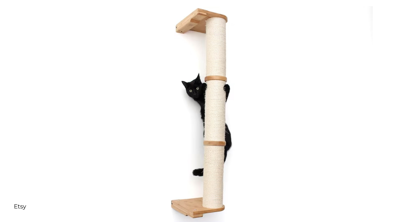 Black cat climbing a mounted cat climber column