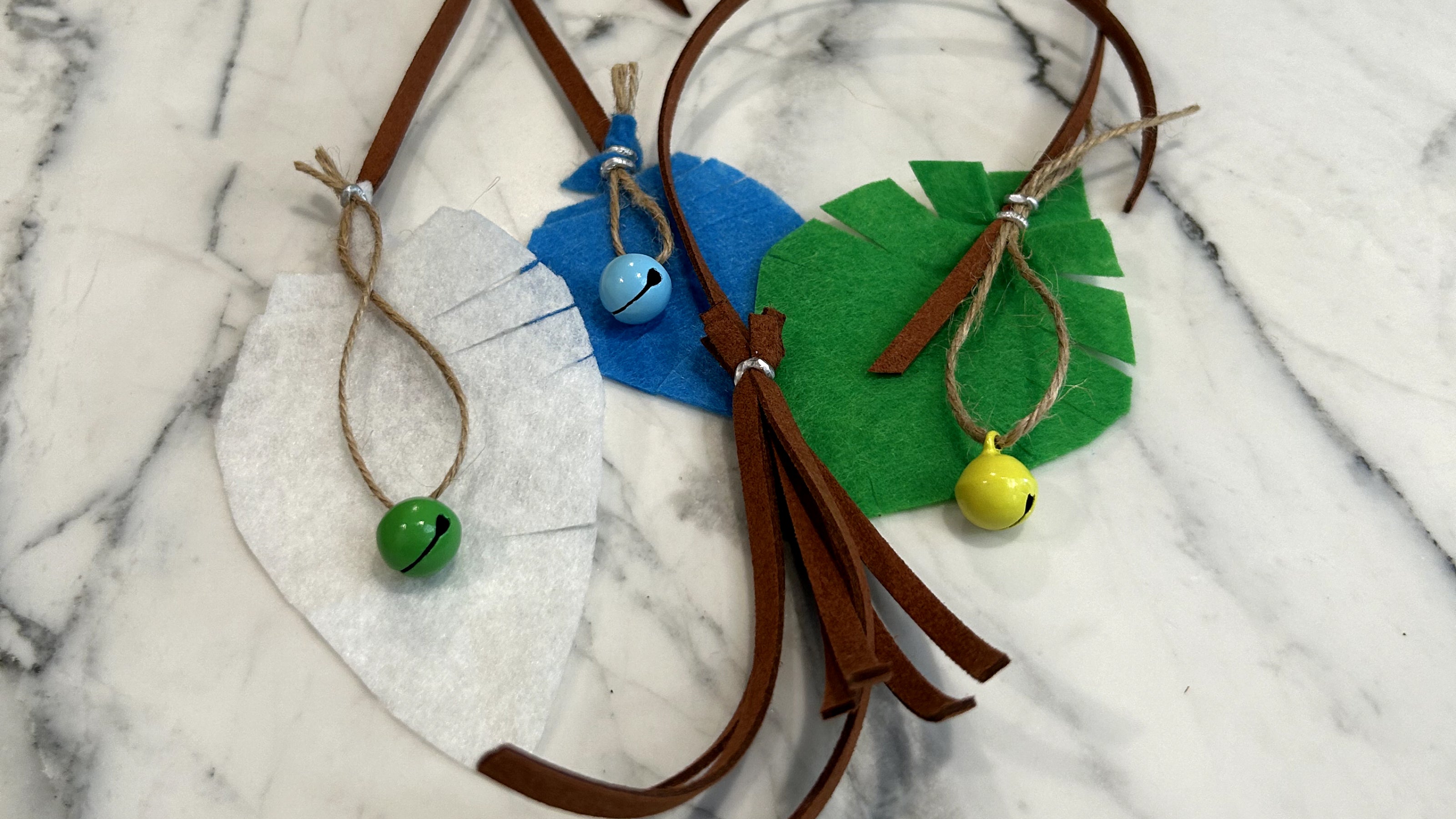 Handmade felt leaves with bells twine and a faux leather tassle